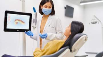 Dentist discussing Invisalign treatment with dental patient