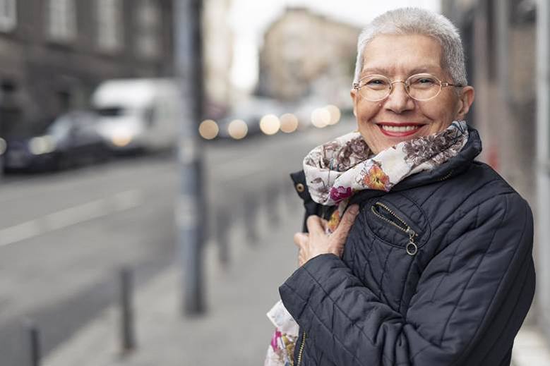 Woman smiling with dentures in Edmonton