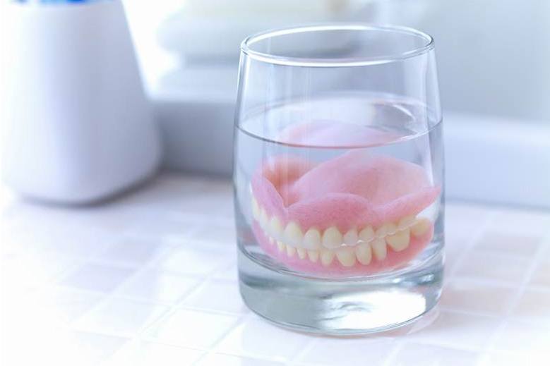 Dentures soaking in glass