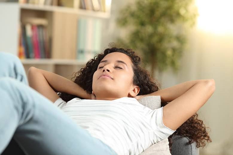 Woman resting after tooth extraction in Edmonton