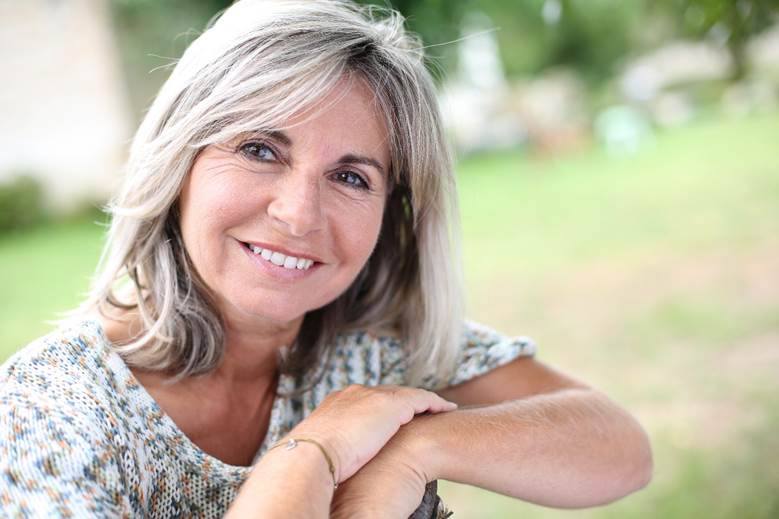 patient smiling after getting dental implants in Edmonton