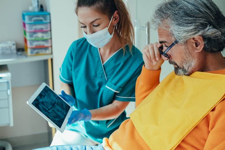 a patient visiting their dentist for dental implant placement in Edmonton, AB